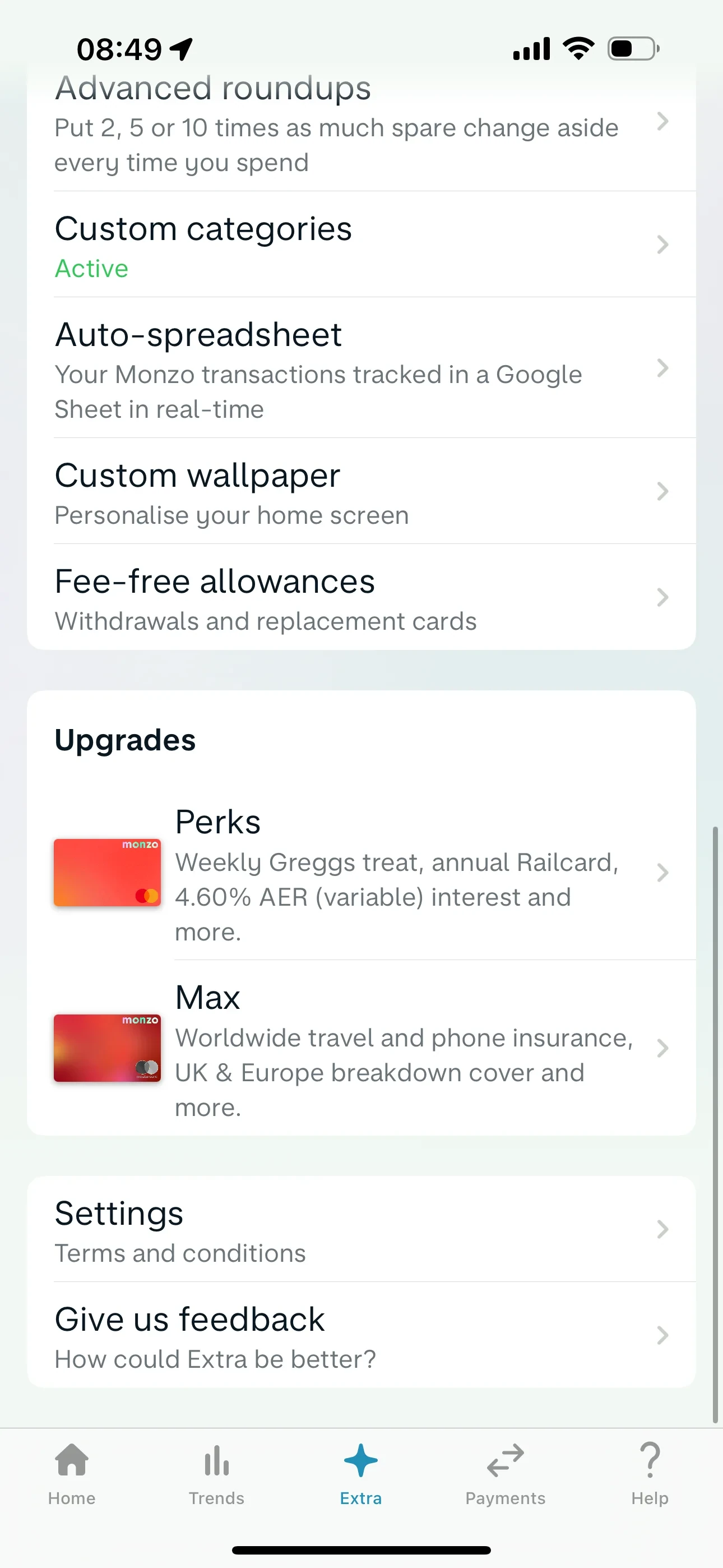 Bottom of the Monzo Extra tab showing benefit rows for Custom categories, Auto-spreadsheet and Fee-free allowances, then an Upgrades block offering Perks and Max, then Settings labelled Terms and conditions above Give us feedback
