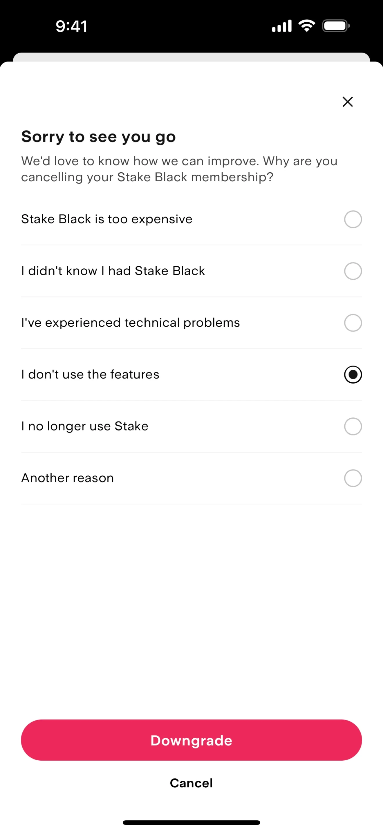 Stake Sorry to see you go survey with I don't use the features selected, an enabled pink Downgrade button, and a Cancel link underneath