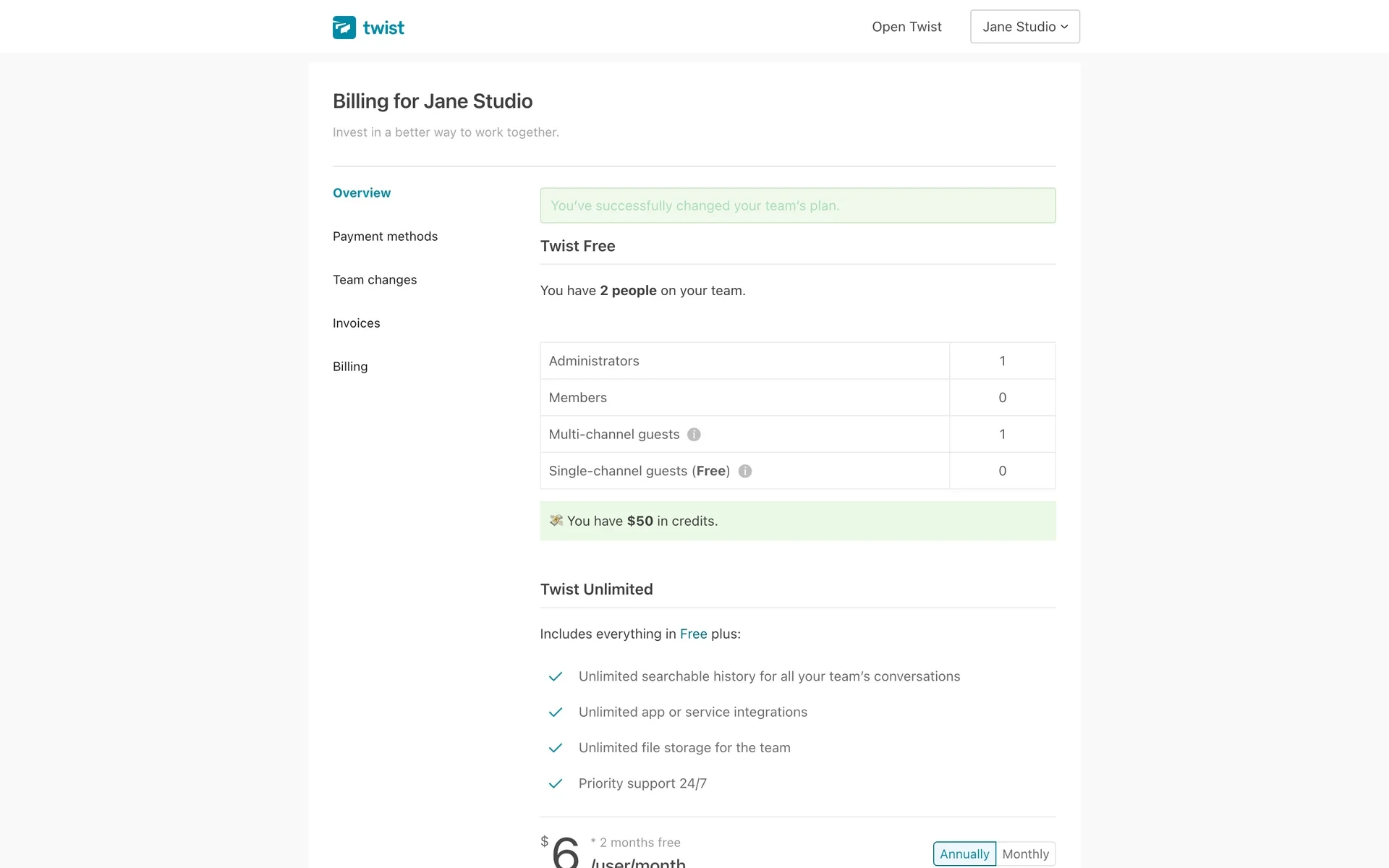 Twist Billing overview after downgrade with a green You've successfully changed your team's plan banner, Twist Free as the current plan for 2 people, account credits shown, and a Twist Unlimited upgrade card listing unlimited history and storage