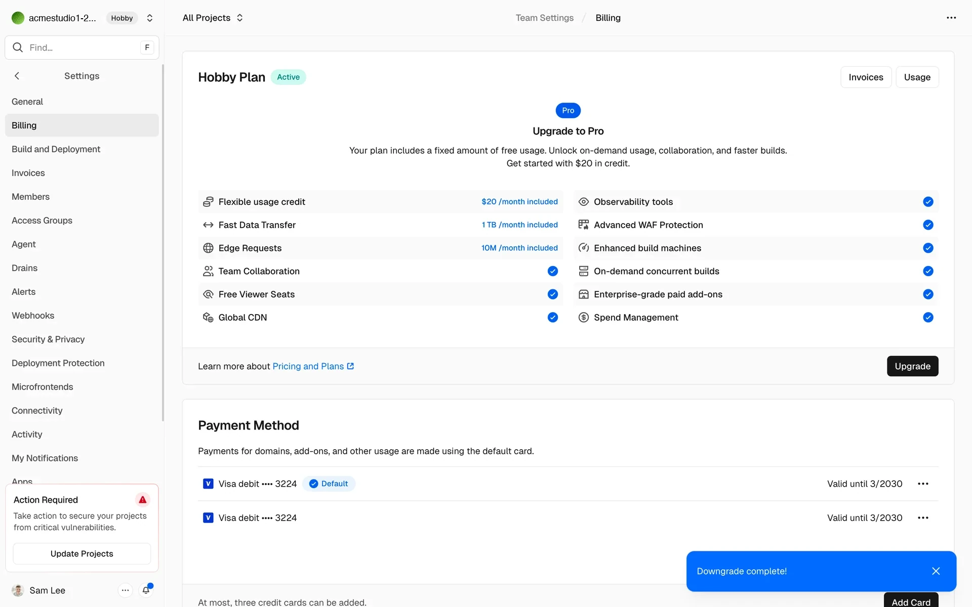 Vercel Billing page after downgrade showing Hobby Plan with a green Active badge, Upgrade to Pro feature list, Payment Method cards, and a blue Downgrade complete toast